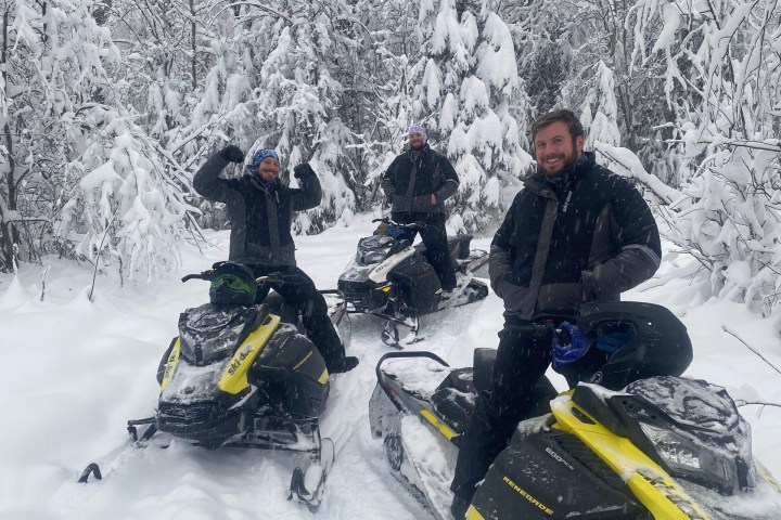 a couple of people that are sitting in the snow