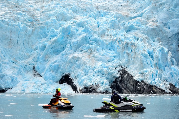 a group of people riding skis on a body of water