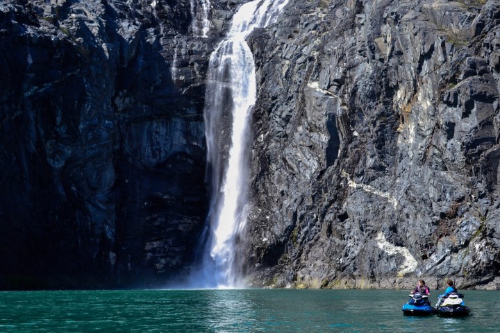 a large waterfall over some water