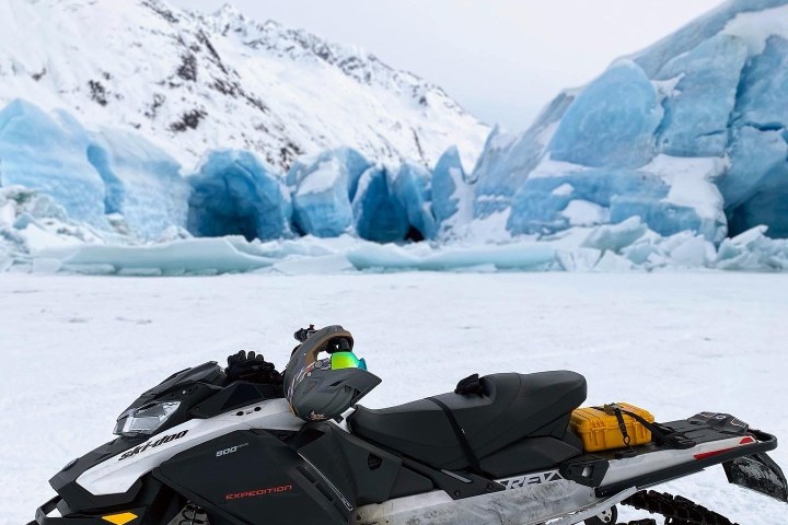 a person lying on top of a snow covered mountain