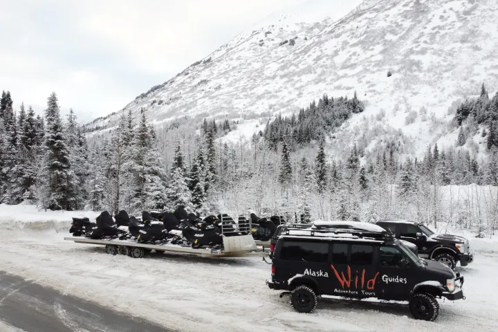 a car parked on the side of a snow covered mountain