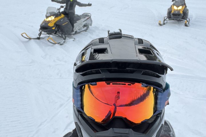a person sitting on a snowmobile